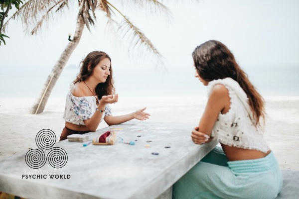 woman symbolon card reading on the beach