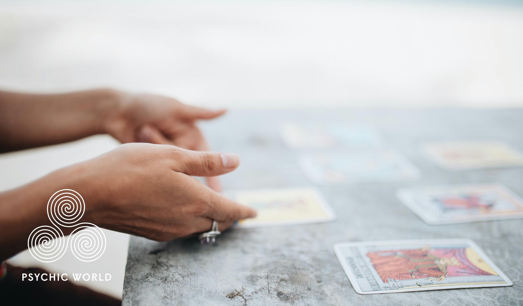 woman flipping tarot cards on a table