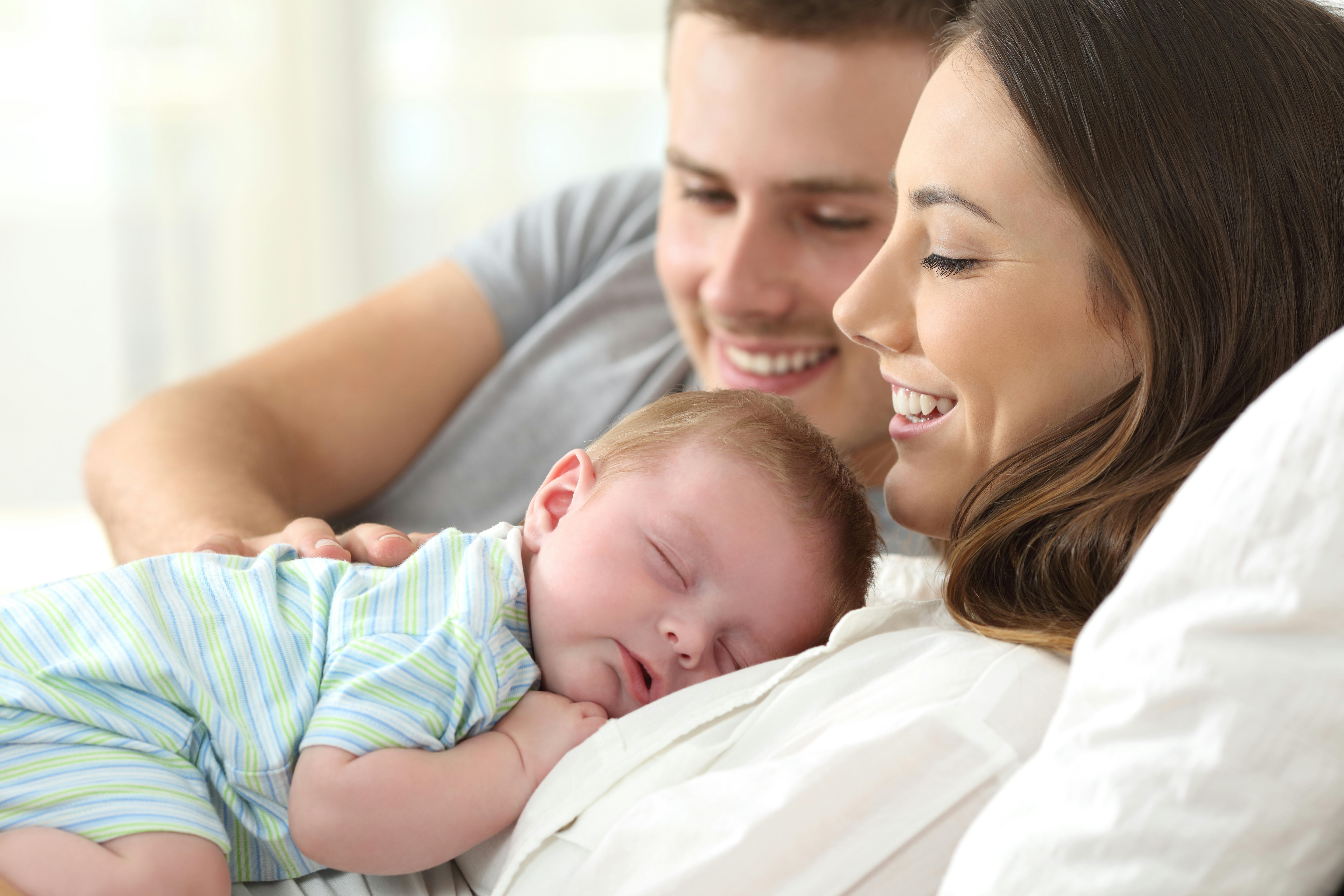 couple with their baby hugging