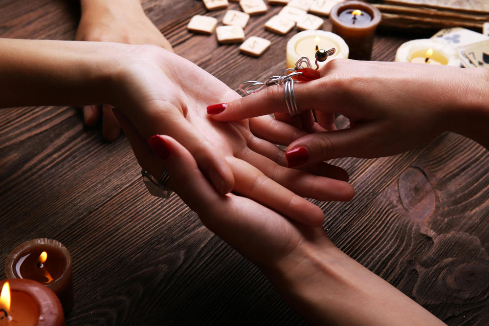 A fortune teller reading fortune close-up.