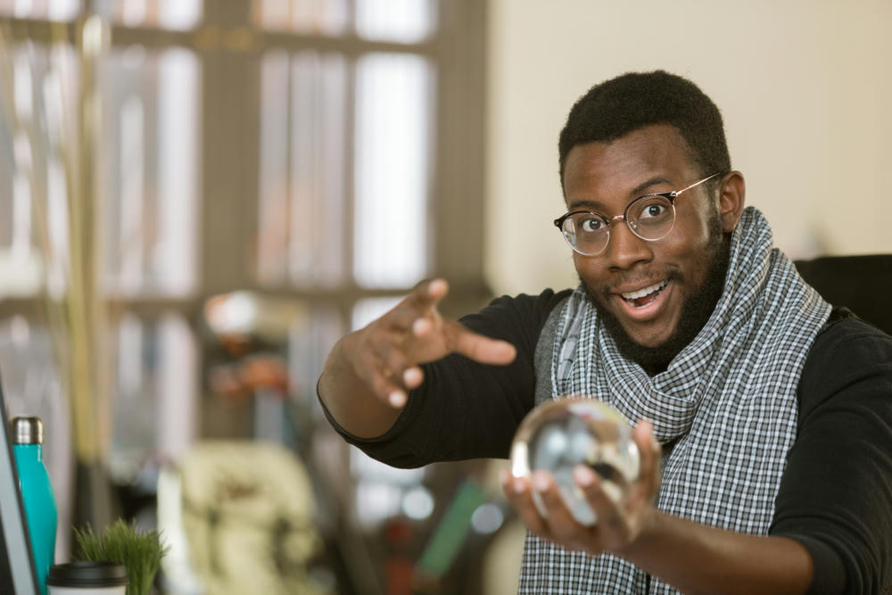 Confident creative professional man with a crystal ball.