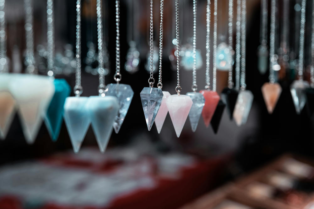 Magical neck pendants in different variations: black, white, green, and pale blue.
