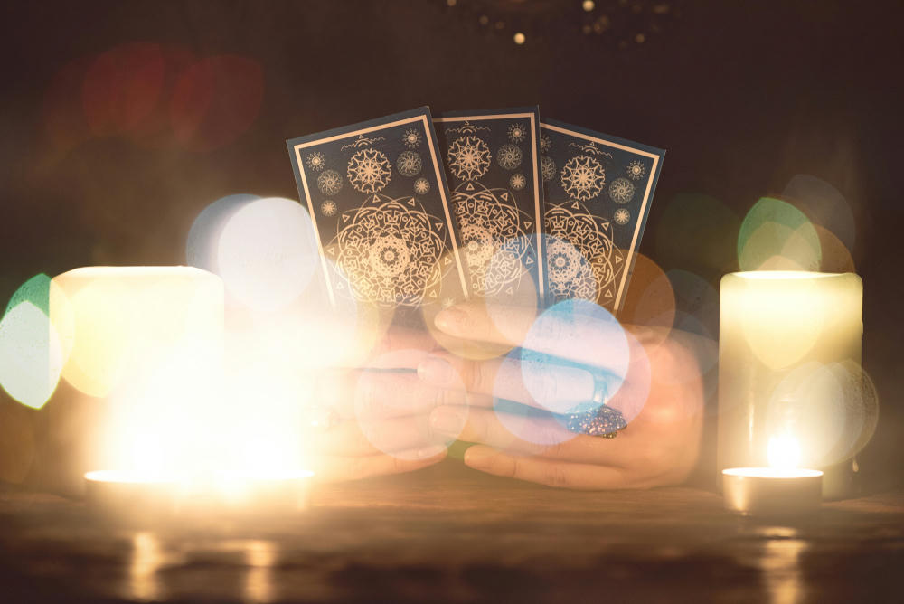 Fortune teller with tarot cards in hands close up. Future reading concept.