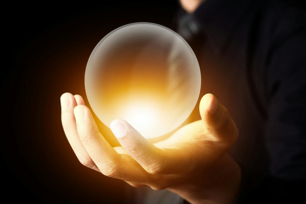 Businessman holding a crystal ball.